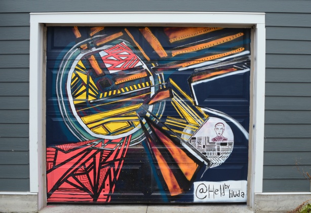 street art mural on a garage door by artist with instagram handle heldbyhuda 