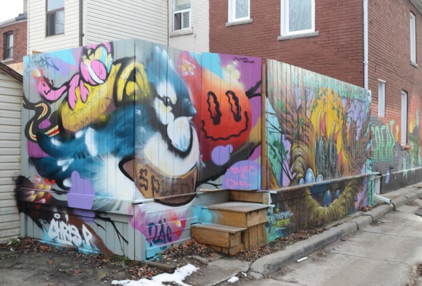 murals on a wood fence in a lane, tomato, blue jay
