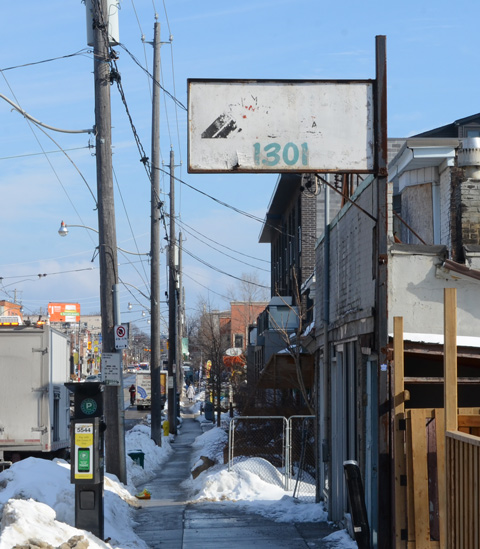 old sign at 1301 Gerrard East, sidewalk in winter, 