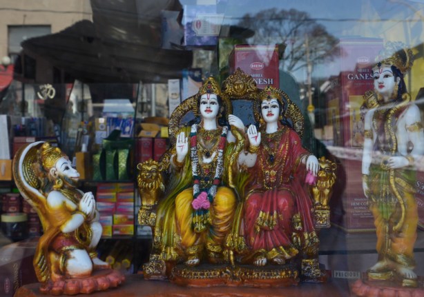 gold and cololurful little statues in a store window