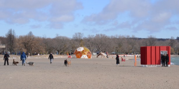 Toronto waterfront, by Ashbridge Bay, Lake Ontario, winter stations 2022, people and dogs on the beach with a few art installations