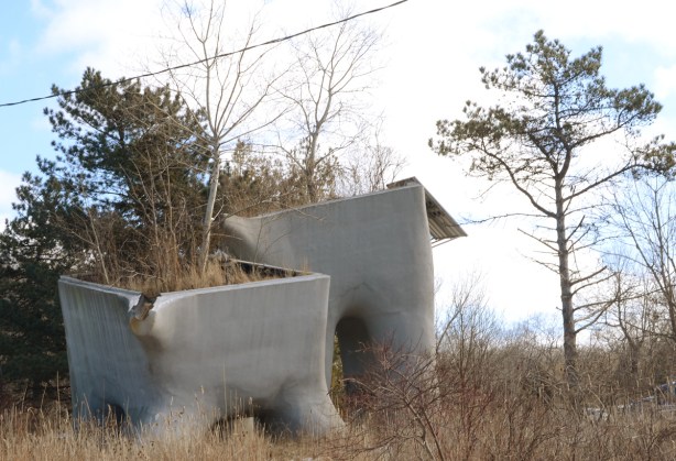 large concrete containers, planters, on a small hill with small trees, winter,