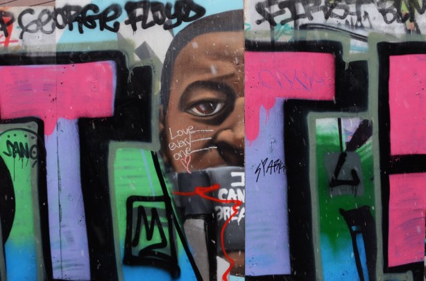 graffiti and street art on plywood hoardings that got switched around