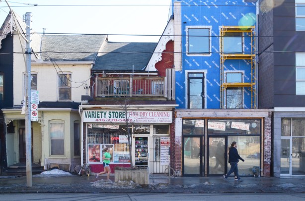 a row of stores on the south side of Queen East, with different rooflines after various alterations over the years