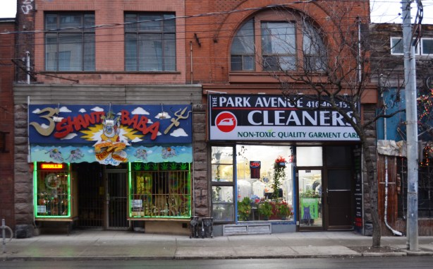 two storefronts in old brick building, Queen West, Park Avenue Cleaners and Shanti Baba