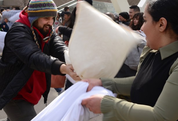 people participating in pillow at nathan phillips square, outdoors, fighting with pillows