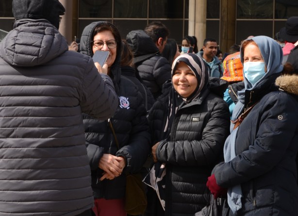 three older women having their picture taken together at Nathan Phillips Square