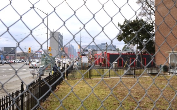 view southward on yonge street, behind chainlink fence 