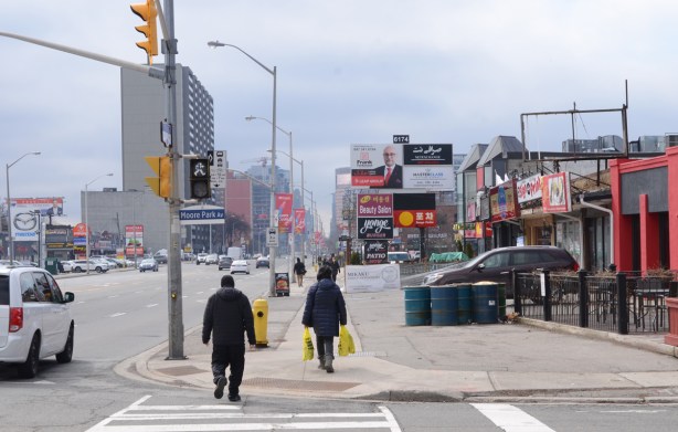 looking south on the west side of yonge from Moore Park Ave., people walking on sidewalk, stores and restaurants 