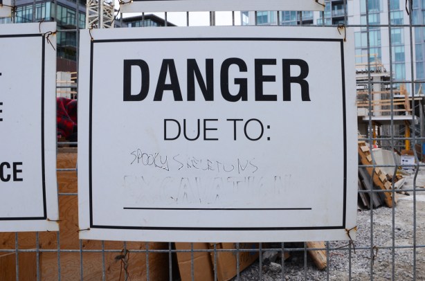 danger due to sign that has been altered to say danger due to spooky skeletons