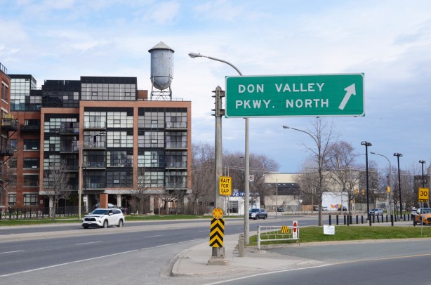 old water tower on top of newer residential development, street sign pointing to ramp from Eastern Ave to Don Valley parkway northbound
