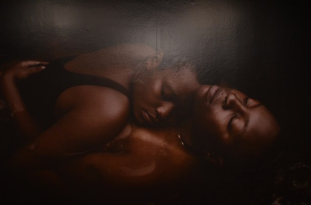 two black people with eyes closed in inimate embrace