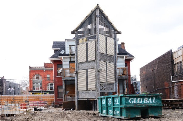 back of an empty building on Queen East, construction site, large green dumpster