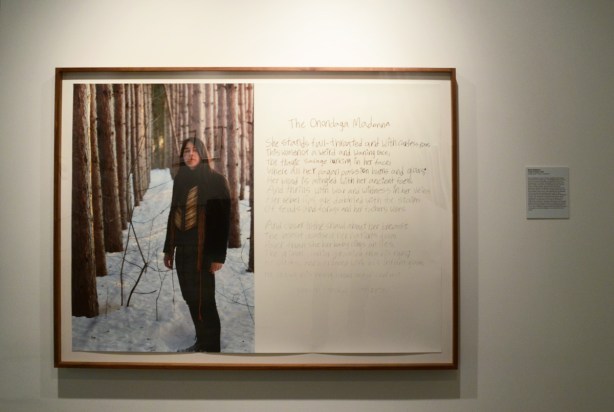 Meryl McMaster portrait, in the woods in winter, alongside a hand written poem called Onondaga Madonna
