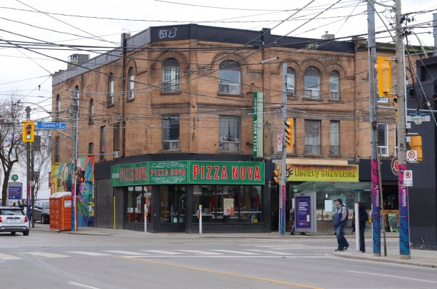 northeast corner of Queen and Broadview, three storey brick building, Pizza Nova on the corner,