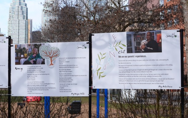 portraits and stories of nancy and chet, each on their own poster board on display outside in a park 
