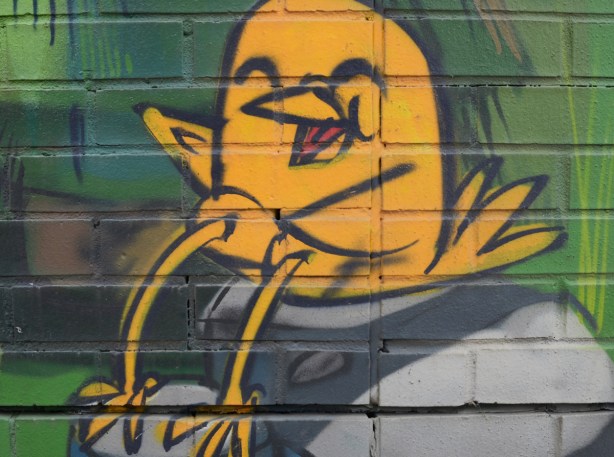 an uber 5000 yellow birdie on a mural