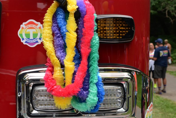 plastic fuzzy garlands on front of a fire truck