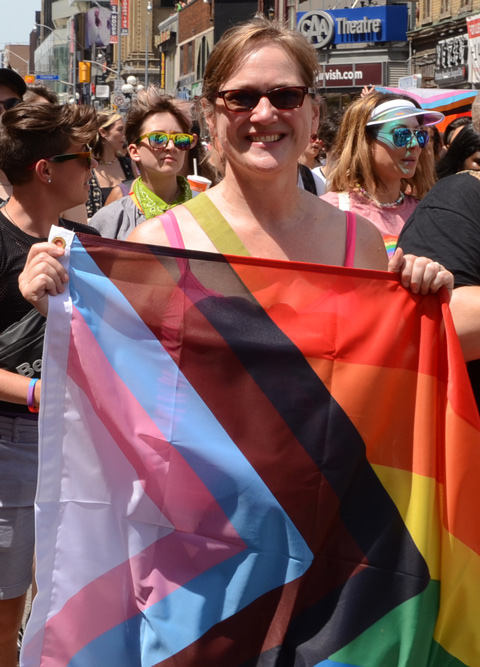 woman carrying flag in dyke march