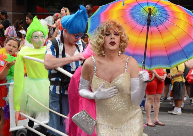 marilyn munro air kissing, under rainbow umbrella, white dress and gloves and sparkly silver purse