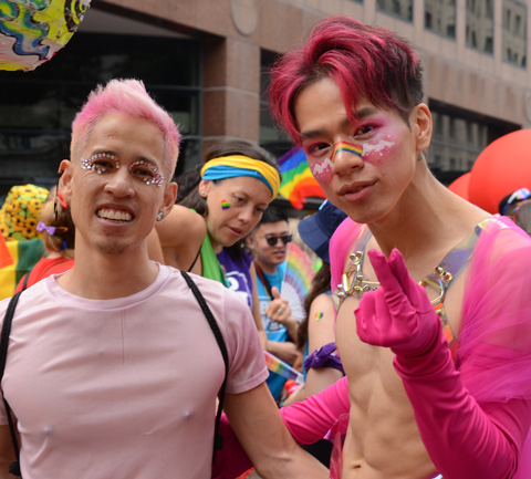 two men in pink at pride parade