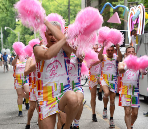 group dancing, choreography, with pink puffs in each hand, practising before the pride parade