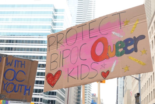 placard at pride parade that says protect bipoc queer kids
