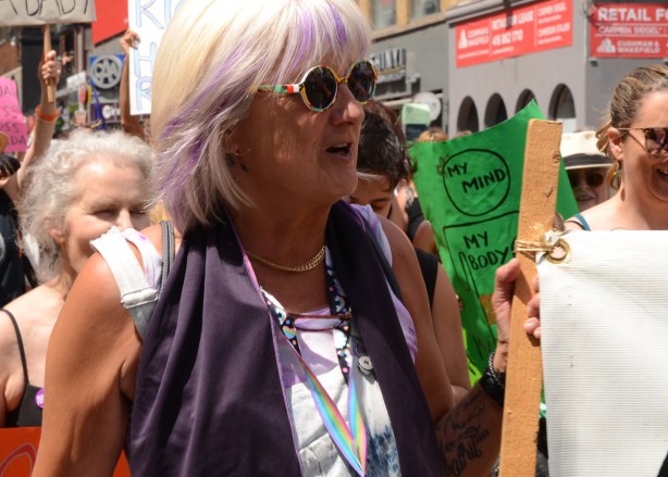 woman with gray and lavender hair in dyke march