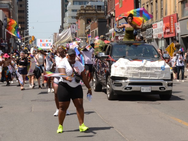 womens health float in dyke march with women dancing beside the car