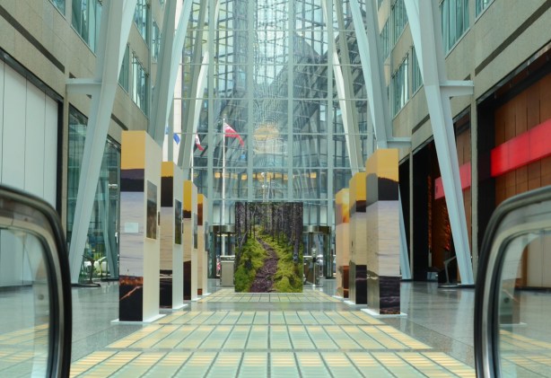 interior of Brookfield Place, a large photo of a path through a forest is standing in the middle