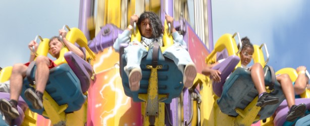 people with concerned looks on face as they free fall in a ride at the CNE