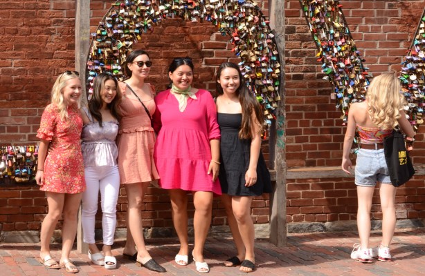 4 young women pose for a group shot beside the love word made from locks in the distillery district