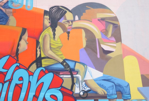 part of a mural by Elicser, a girl in a wheelchair
