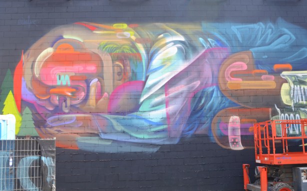 a large mural of a an abstracted person lying on his or her side with knees bent up and face down