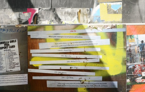 strips of text printed on paper glued to a wall, each strip gives an important date and event in the history of graffiti 