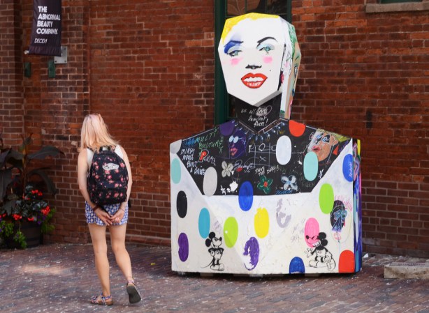 painted sculptures at Distillery District, abstract people shapes, Marilyn Munro type face, Mickey mouse stencils on body