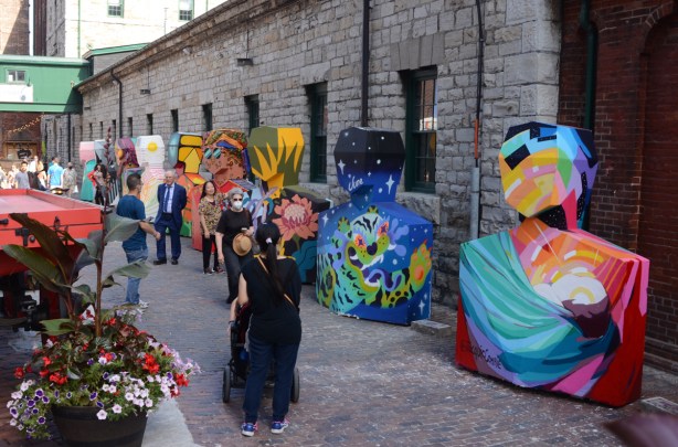 a row of painted sculptures at Distillery District, abstract people shapes, 6ix Art Outdoor exhibit