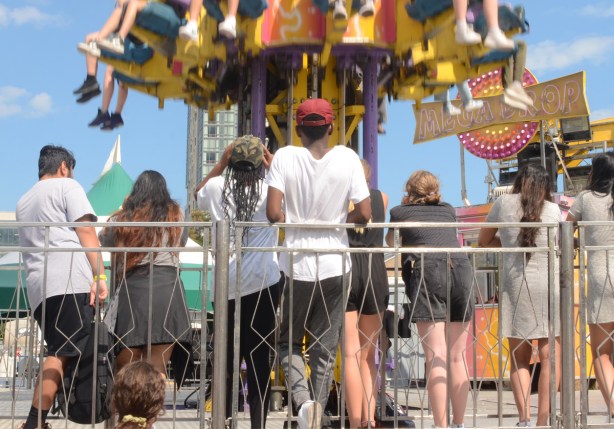 two young men watch a ride 