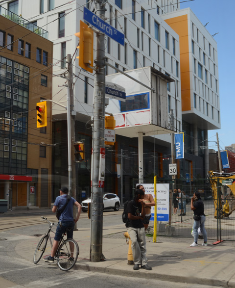 corner of Dundas and Church streets, looking northwest, Ryerson University buildings, a man on a bike waiting for a green light