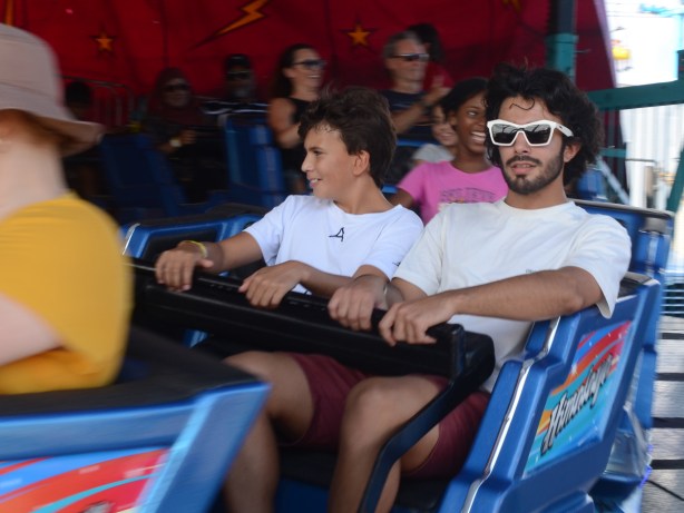 a young man in white framed sunglasses, midway ride at cne