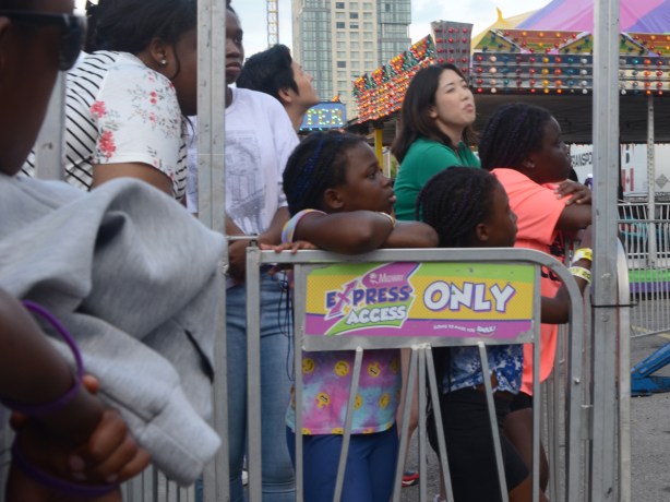 people waiting their turn to get on a ride at the cne