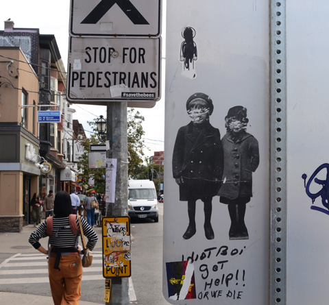 33 wallflower slap on back of traffic sign, two children in period clothing, sidewalk scene beside the sign