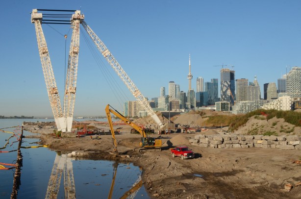 view from the Cherry Street bridge new bridge, towards Lake Ontario, Toronto skyline in the background, construction equipment in the foreground for the redevelopment of the Port Lands 