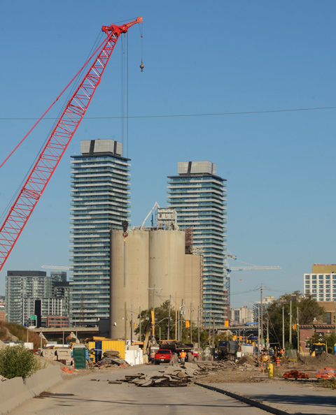 port lands construction site, starting to tear up the old part of Cherry Street, distillery district condos in the background 