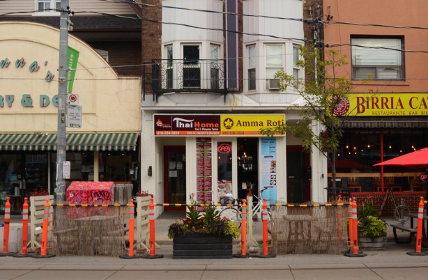3 store fronts on Roncesvalles, Thai restaurant, Amma Roti place, and 