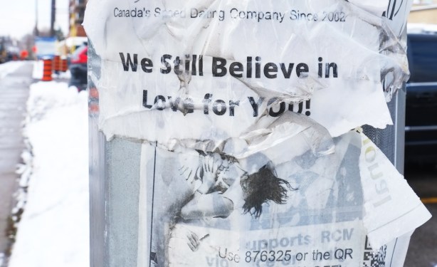 torn poster on hydro pole that says we still believe in love for you, ad for a speed dating service, ripped, torn
