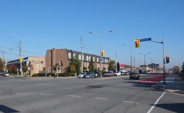 2 rows of townhouses at Galloway road and lawrence in West Hill, intersection of two major streets, lots of lanes of traffic