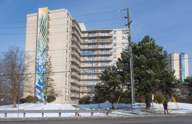 tall horizontal murals on the sides of apartment buildings at Overture Blvd, on Lawrence