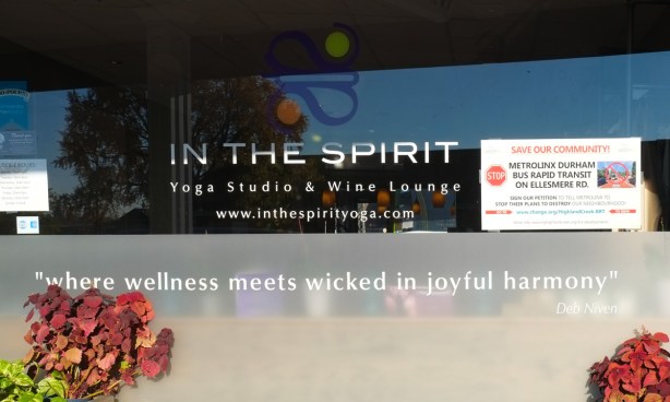 looking in the window of In the Spirit a yoga studio and wine lounge with the motto wellness meets wicked in joyful harmony