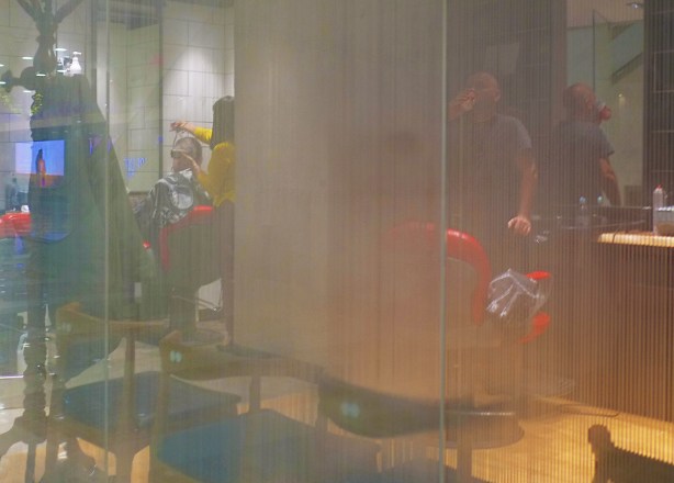 looking in the window of a barber shop or hair stylist, partially translucent window 